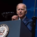 Investigating Controversies: Are Biden’s Pardons Marred by Corruption Claims? Man speaking at podium with presidential emblem visible
