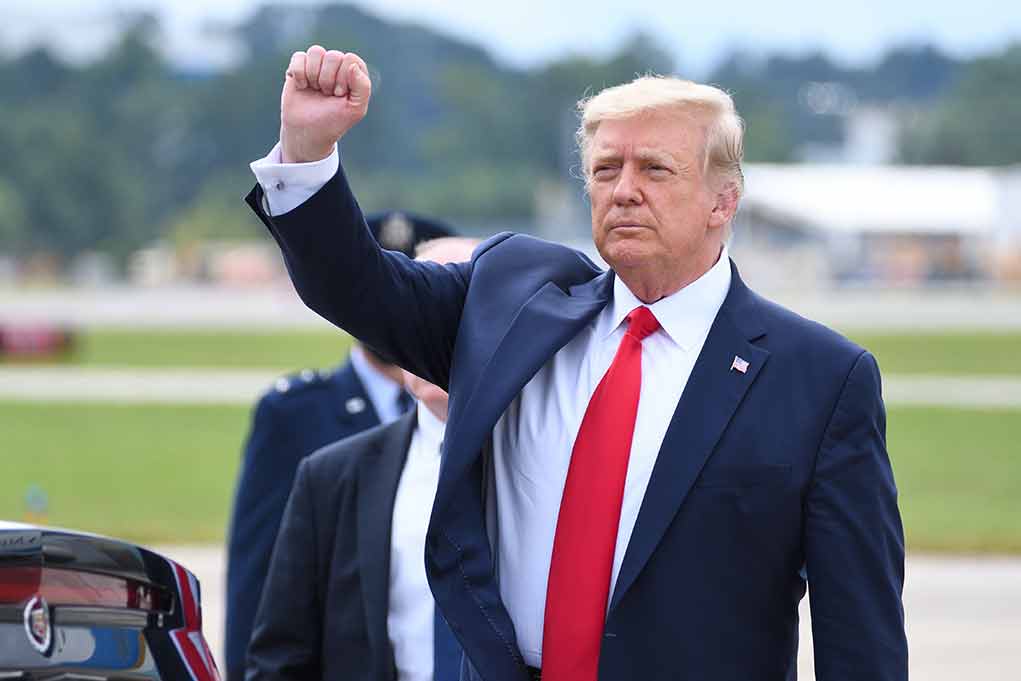 1821865592 featured image Man in suit raising fist outdoors near vehicle