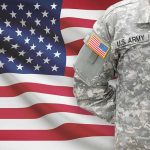 How Federal Hiring Freeze Could Transform Veterans’ Healthcare and VA Operations US soldier in camouflage uniform with American flag