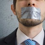 Censorship Claims Shake Politico: A Threat to Media Integrity? Person with duct tape over mouth in suit