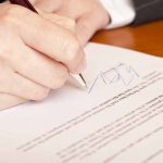 Cuba’s Removal from Terrorism List: What It Means for US Relations Hand signing a document with a pen