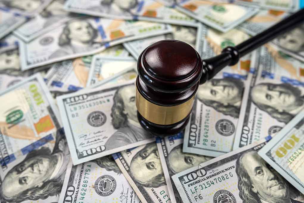 2200663999 featured image Gavel on pile of hundred dollar bills