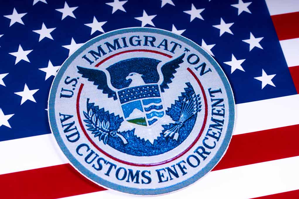 1055129168 featured image ICE seal over American flag background