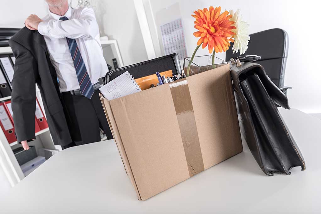 Worker packing up his belongings after being fired.
