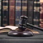 Gavel and open book in library setting