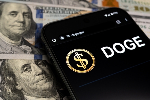 2591039935 featured image Smartphone displaying Doge logo on hundred dollar bills