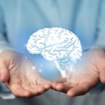 Unpacking ADHD: Debunking Common Beliefs and Emphasizing Individualized Treatment Hands holding a holographic brain visualization