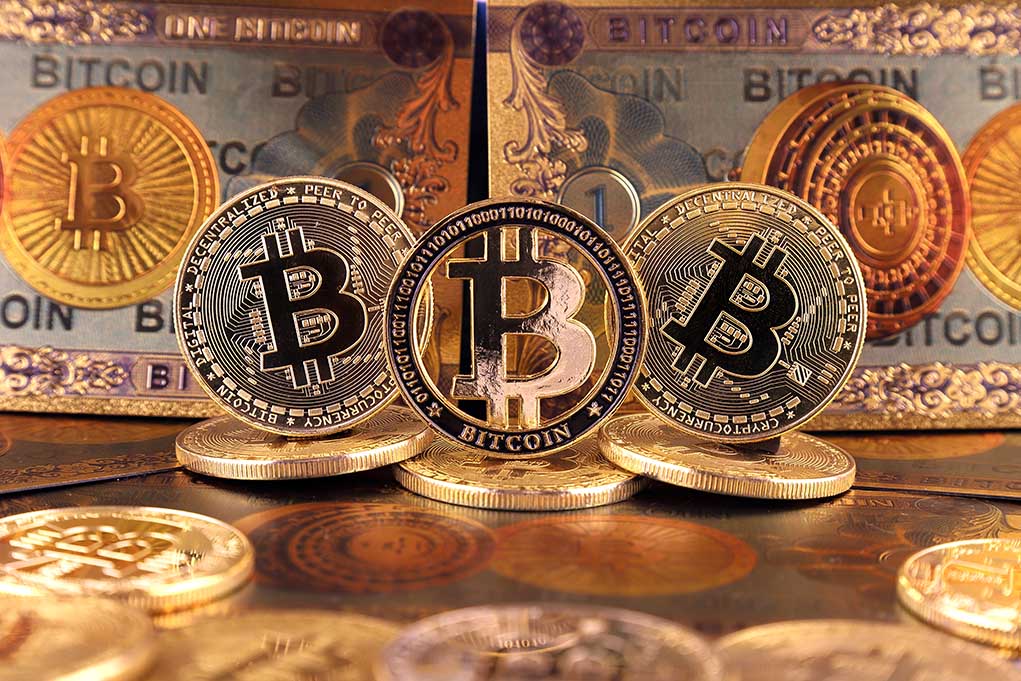 1930952738 featured image Bitcoin coins and bills displayed closely