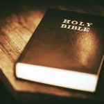 A Holy Bible on a wooden table