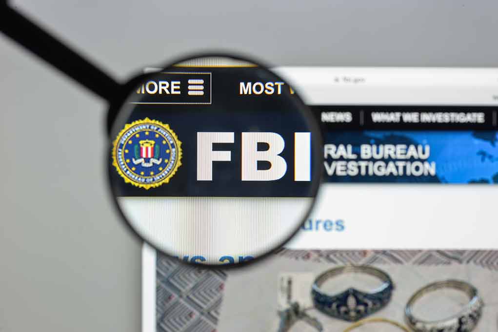 "FBI website shown through magnifying glass."