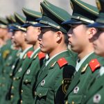 Chinese military personnel standing in formation.