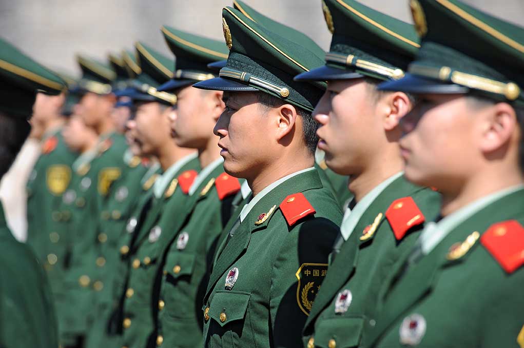 Chinese military personnel standing in formation.