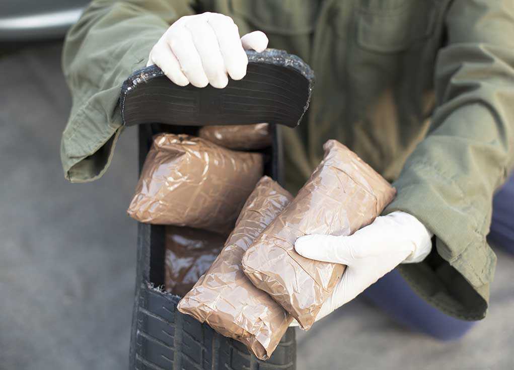 160035851 featured image Person handling packages wearing gloves and green jacket