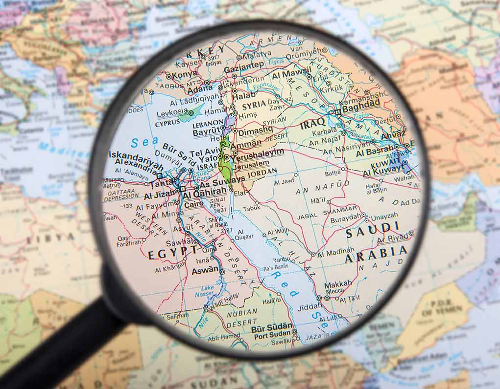 Magnifying glass focused on the Middle East map