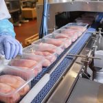 Shoppers WARNED: Toxic Food Pulled From Stores Packaged chicken breasts on a factory conveyor belt