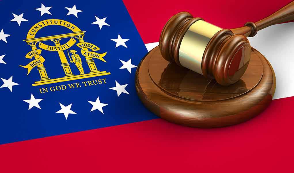 Georgia flag and judges gavel on wooden base