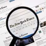Magnifying glass over The New York Times website