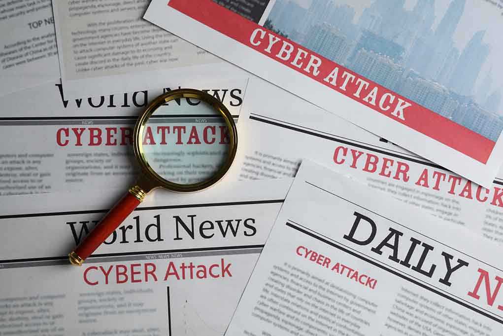 1897700383 featured image Newspapers with Cyber Attack headlines and a magnifying glass