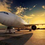 Boeing 737 Max Panic—Emergency Slide Activated! An airplane parked on the runway during sunset with a colorful sky
