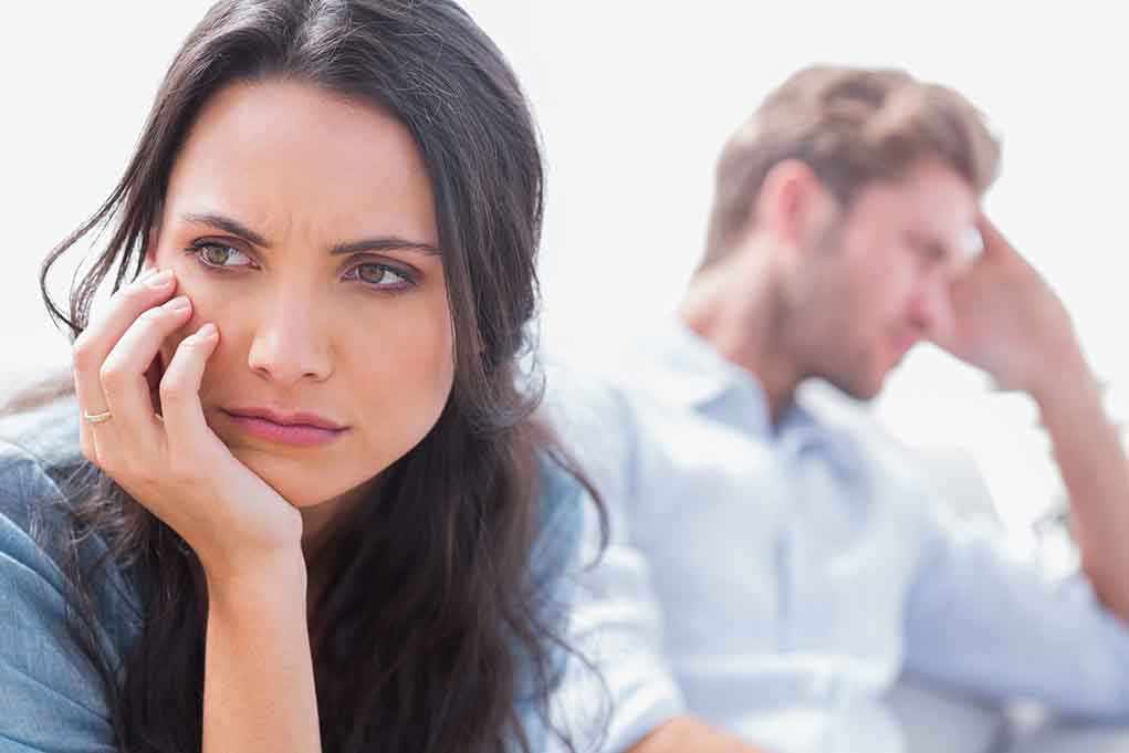 shutterstock_143673787.jpg A woman looking concerned while a man appears distressed in the background