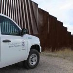 Mexico Outraged: Nationals Held in US Facility Border protection vehicle near a large metal fence