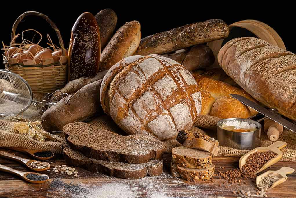 Assorted breads with seeds and baking ingredients
