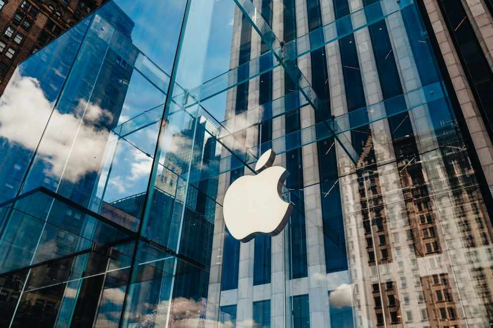 Apple store with glass facade and city reflections