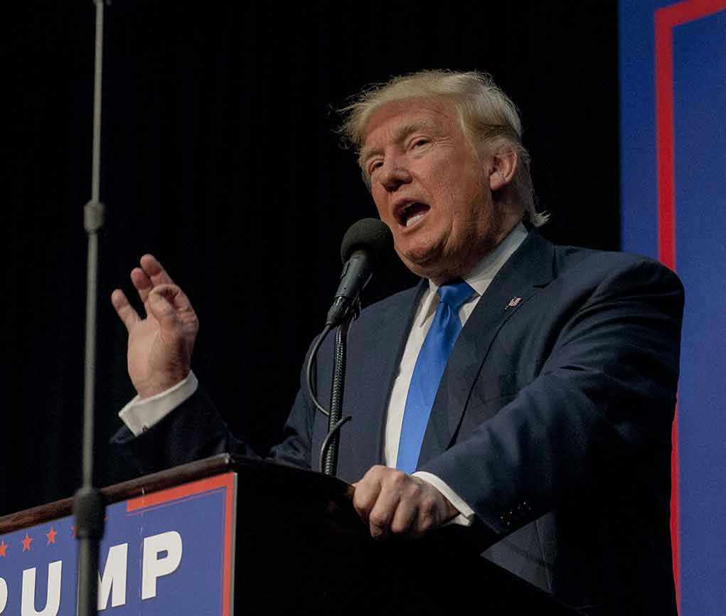 Person speaking into microphone at a podium