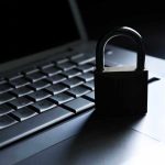 Massive Data Leak Hits Major Medical Provider A padlock resting on a laptop keyboard in a dimly lit environment