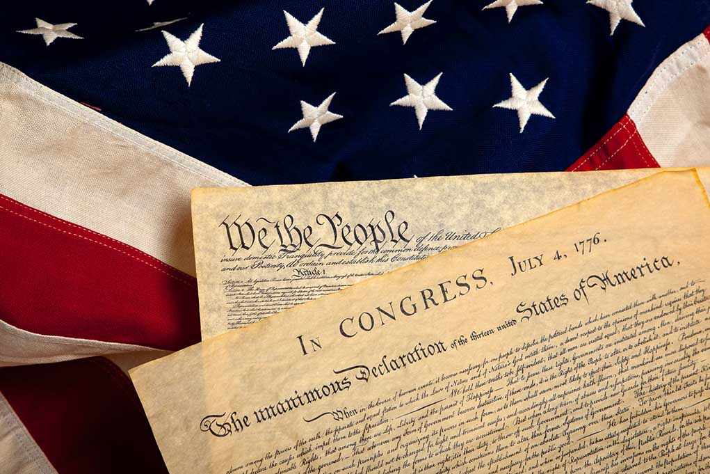 shutterstock_40563325.jpg The Declaration of Independence laid on an American flag