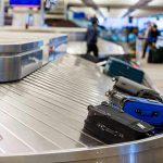 Shocking Luggage Scam Exposes Traveler Data Luggage on airport baggage claim conveyor belt