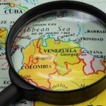 Colombian Leader’s Shocking Call Sparks U.S. Fury Magnifying glass focusing on Venezuela and Colombia on map