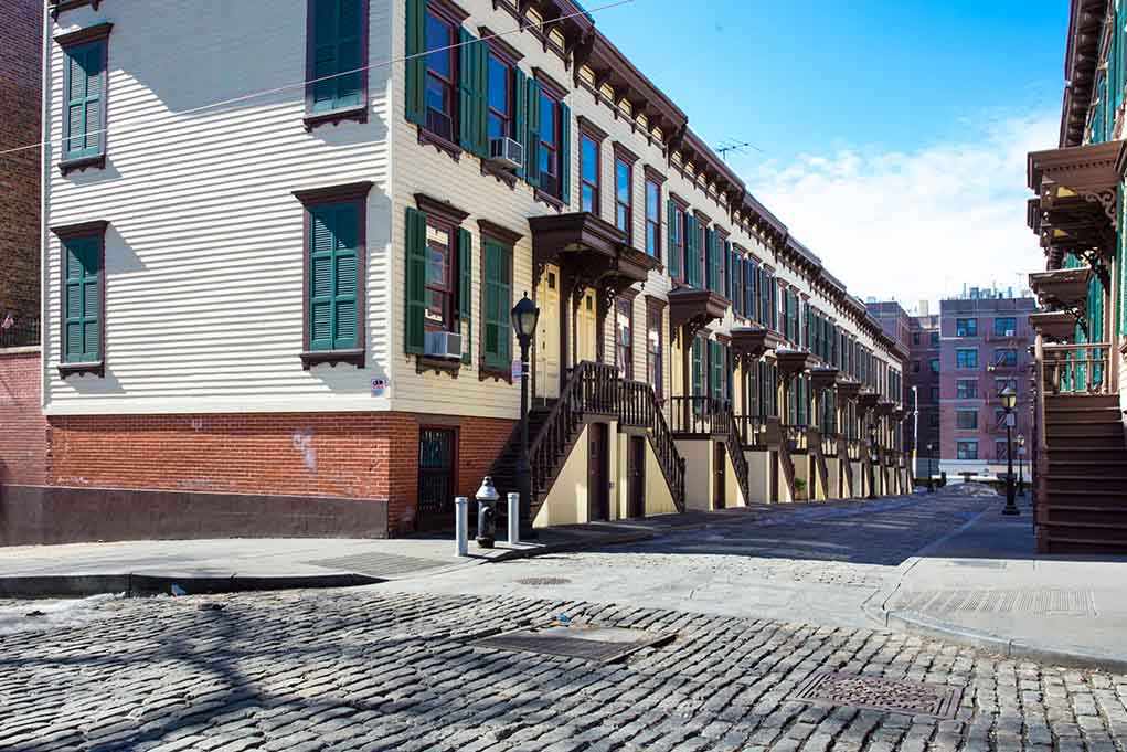 shutterstock_190523168.jpg Row houses along a cobblestone street in an urban setting