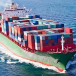 Chaos Erupts: 67 Containers Plunge at U.S. Port A large cargo ship loaded with colorful containers sailing on the ocean