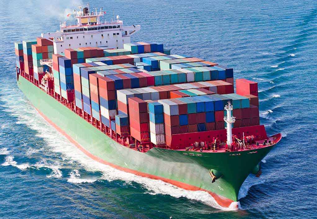 A large cargo ship loaded with colorful containers sailing on the ocean