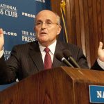 Giuliani Crash Chaos Stuns Police A man in a suit speaking at a podium during a press conference