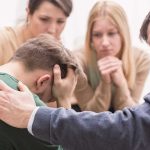 Over A Million Seek Help: ChatGPT’s Dark Reality Group comforting a distressed person with hand on shoulder