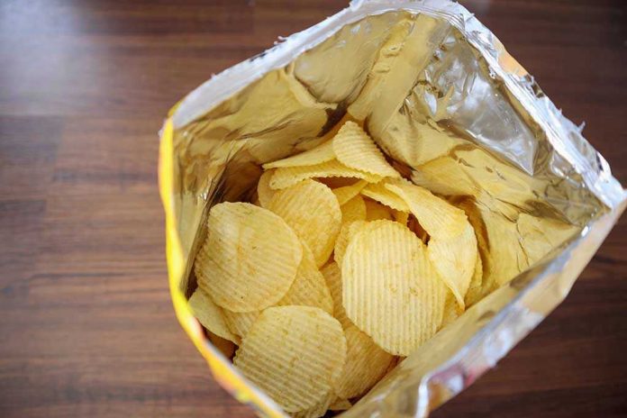 1142853884 Open bag of ridged potato chips