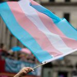 Transgender ID Plunge: Culture Shift Bombshell Transgender flag waving in a crowded street