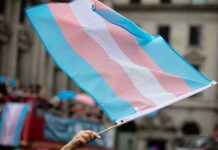 Transgender ID Plunge: Culture Shift Bombshell Transgender flag waving in a crowded street