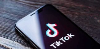 Phone screen showing TikTok logo and app
