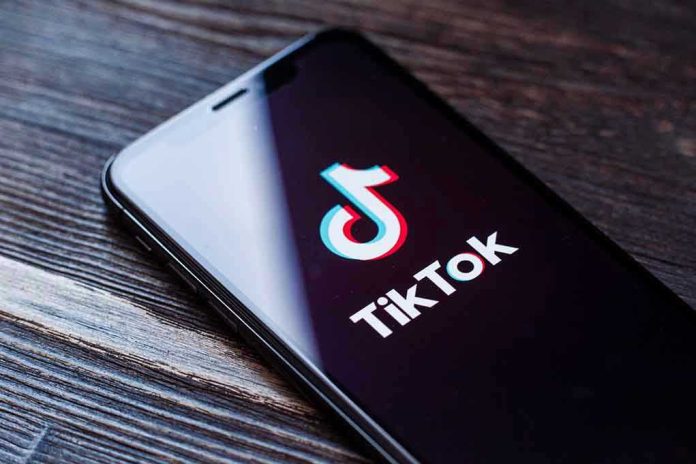 1455492983 Phone screen showing TikTok logo and app