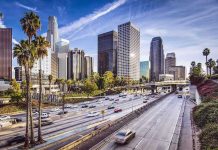 Illegal Alien RAMS Federal Agents — Marshal Shot Downtown cityscape with skyscrapers and highway traffic
