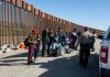Border patrol agents interact with a group of people