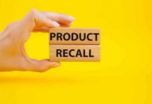 SHOCKING Contamination: Hygiene Products Pulled Hand holding Product Recall blocks on yellow background