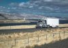 Fatal Crash Fuels Trump’s Visa Crackdown Truck driving on rural highway near river and mountains