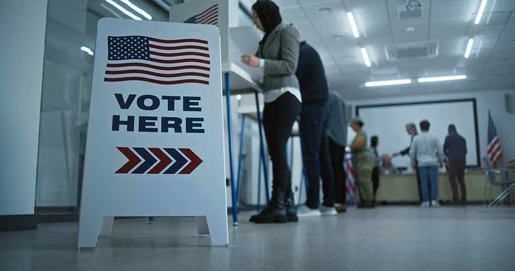 Sign reading Vote Here in a polling station