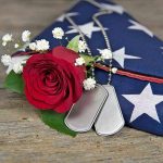Dog tag red rose and folded American flag