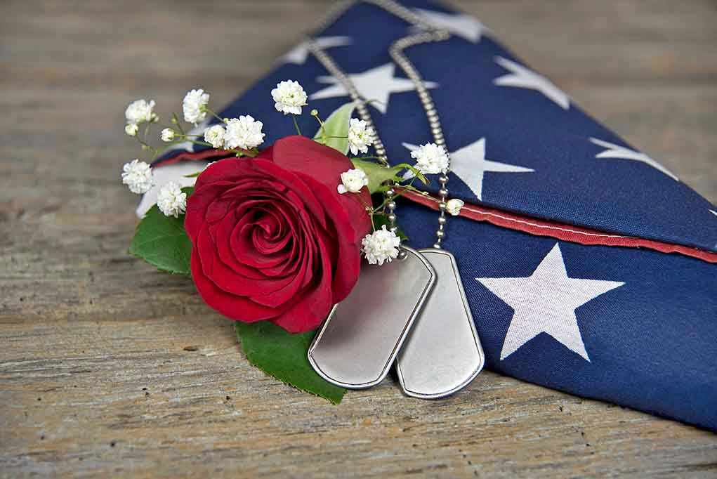 Dog tag red rose and folded American flag