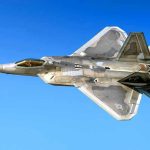 Fighter jet in flight against a clear blue sky